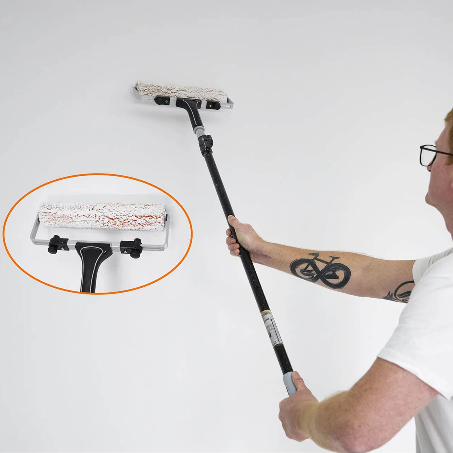 DIY painter using 12 inch paint roller with extension pole for high wall coverage