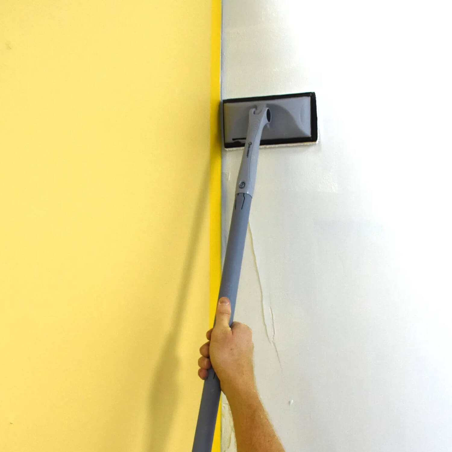 DIY painter using ROLLINGDOG paint pad kit with extension pole to reach high walls and ceilings easily