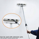 DIY painter using 18 inch paint roller with extension pole for painting high walls efficiently