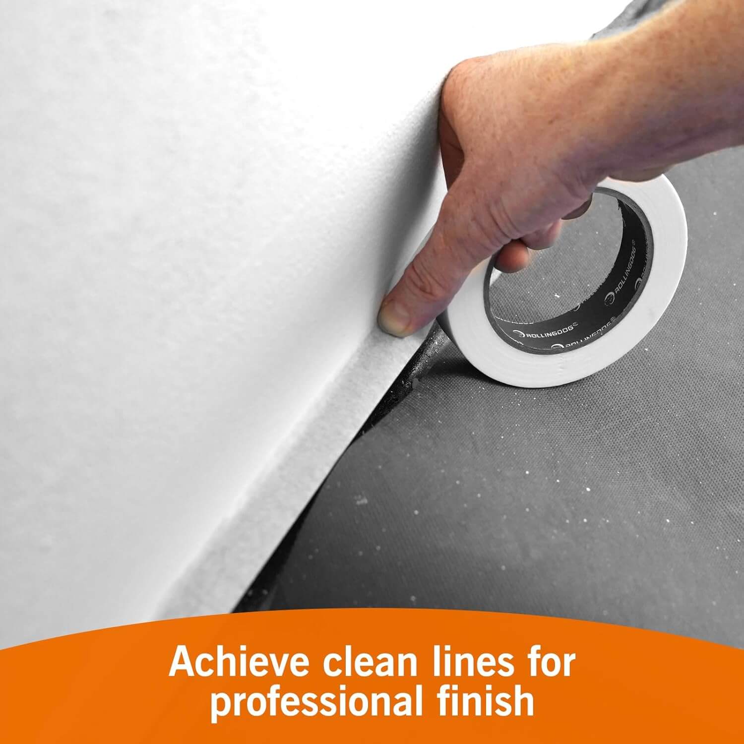 Painter using masking tape to create clean, precise paint lines